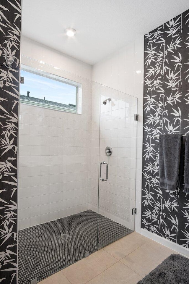 full bathroom featuring a shower stall and tile patterned floors