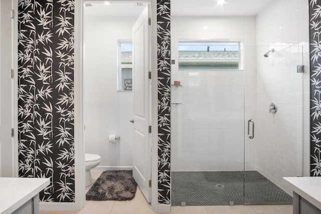 bathroom with a stall shower, baseboards, toilet, tile patterned floors, and vanity