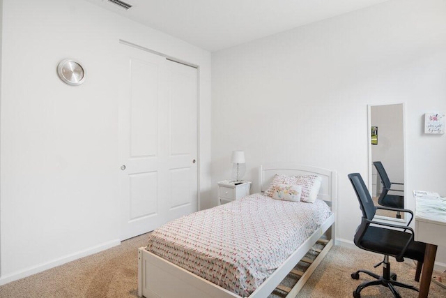 bedroom with baseboards and light colored carpet