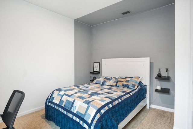 carpeted bedroom with visible vents and baseboards