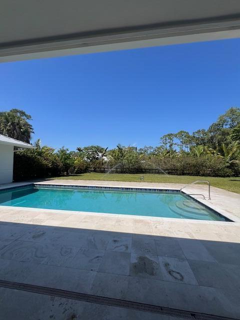 view of swimming pool featuring a patio area and a fenced in pool