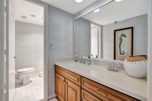 bathroom featuring vanity, toilet, and tile patterned floors