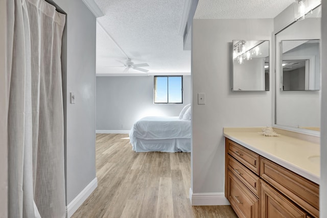 100 Ocean Trail Way Unit 1101, Jupiter, FL 33477 - bathroom featuring a textured ceiling, vanity, wood finished floors, a ceiling fan, and baseboards