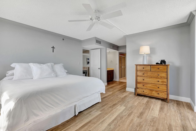 bedroom featuring light wood finished floors, baseboards, a ceiling fan, a textured ceiling, and crown molding