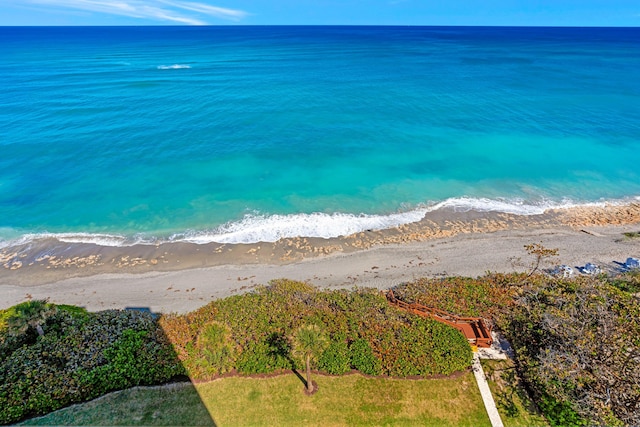 birds eye view of property with a water view and a view of the beach