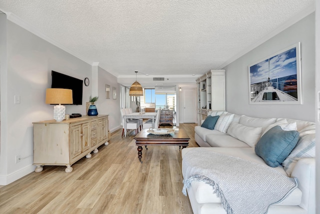 living room with baseboards, light wood-style flooring, and crown molding