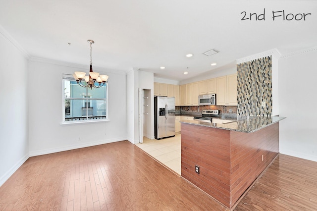 kitchen featuring light wood-type flooring, visible vents, cream cabinetry, appliances with stainless steel finishes, and decorative backsplash