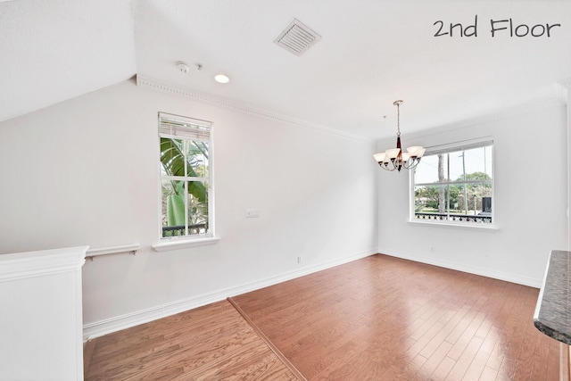 interior space featuring visible vents, plenty of natural light, and wood finished floors