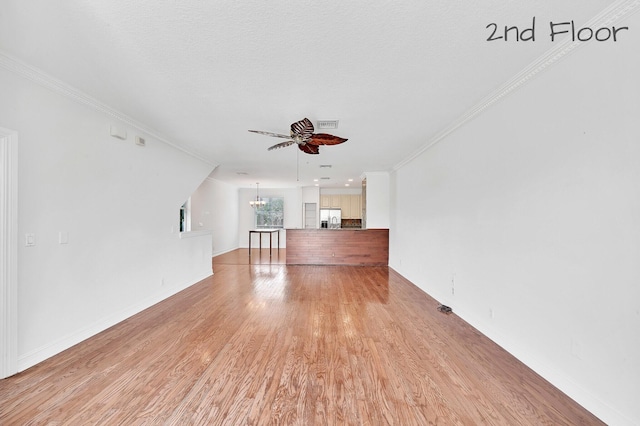 unfurnished living room featuring visible vents, light wood-style flooring, ornamental molding, ceiling fan with notable chandelier, and baseboards