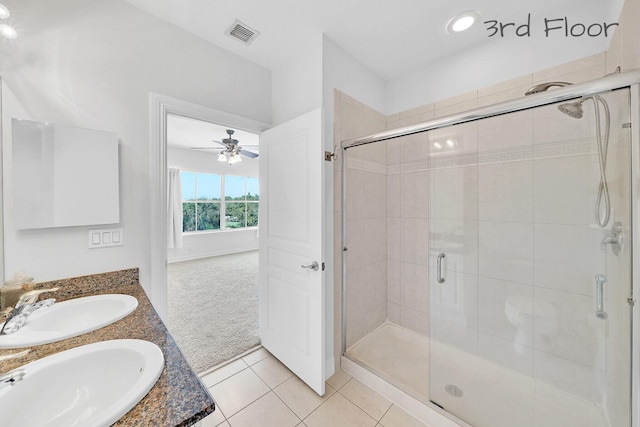 bathroom with tile patterned floors, visible vents, a shower stall, and a sink