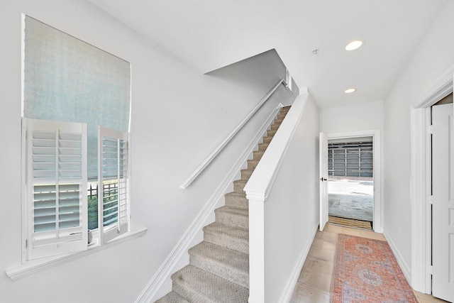 staircase with recessed lighting and baseboards