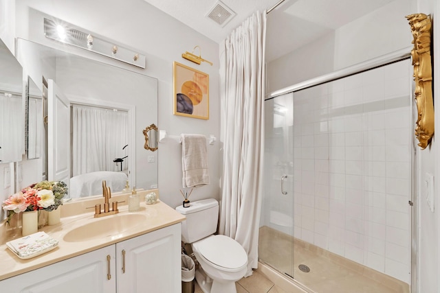 full bath featuring vanity, visible vents, tile patterned flooring, a shower stall, and toilet