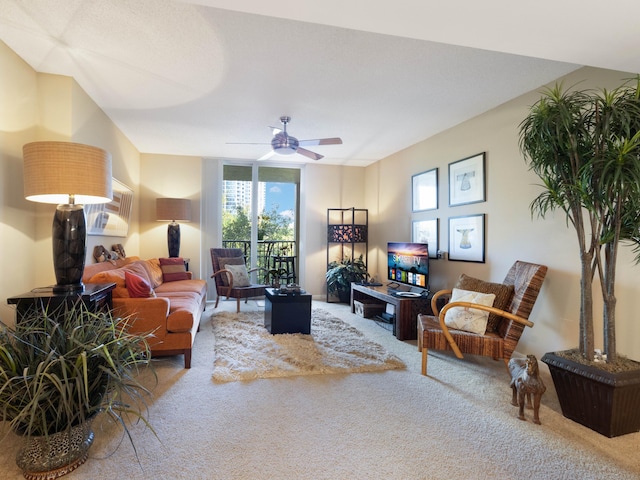 carpeted living area with ceiling fan