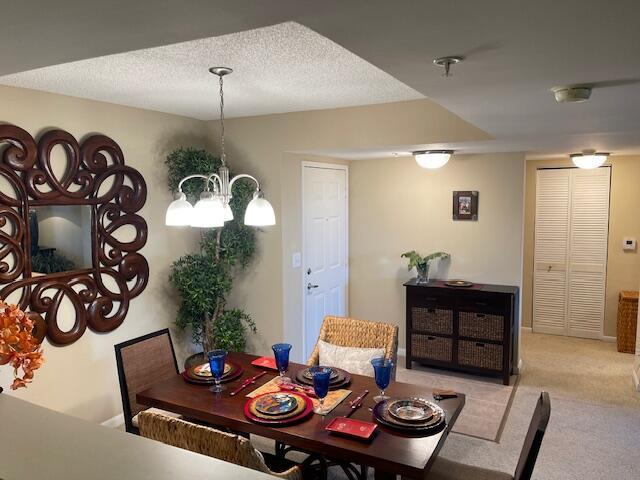 520 SE 5th Ave Unit 2405, Fort Lauderdale, FL 33301 - carpeted dining space with a chandelier and a textured ceiling