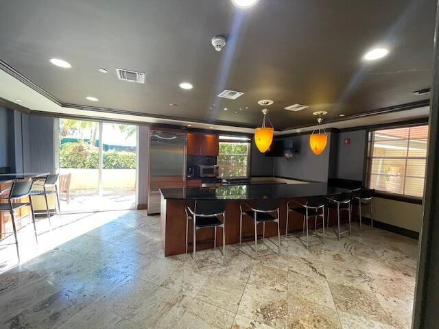 520 SE 5th Ave Unit 2405, Fort Lauderdale, FL 33301 - kitchen with a wealth of natural light, visible vents, dark countertops, and a breakfast bar