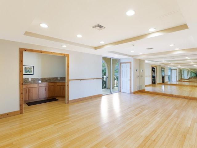 520 SE 5th Ave Unit 2405, Fort Lauderdale, FL 33301 - workout room featuring a tray ceiling, recessed lighting, and light wood finished floors