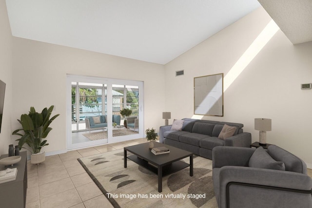 living area with visible vents, vaulted ceiling, baseboards, and light tile patterned floors