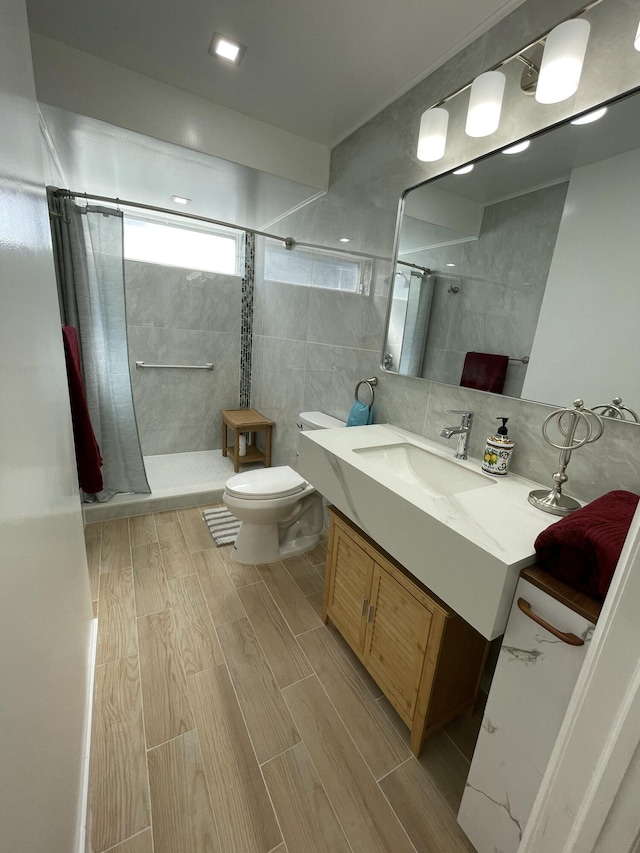 full bathroom with decorative backsplash, tiled shower, toilet, and wood tiled floor