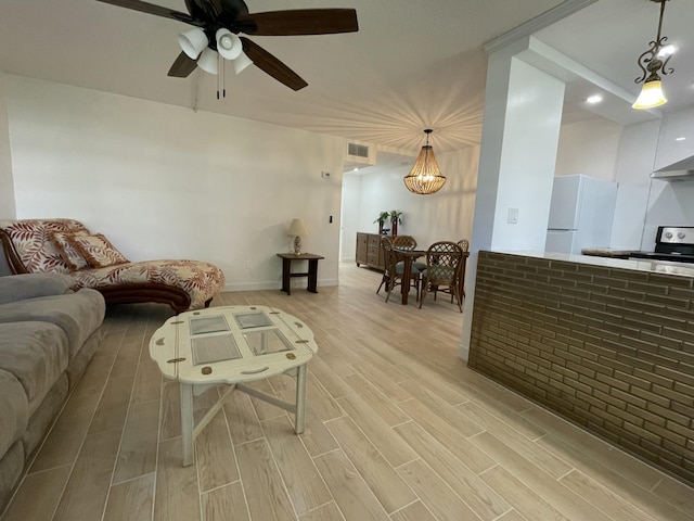 living room with visible vents, a ceiling fan, and wood tiled floor