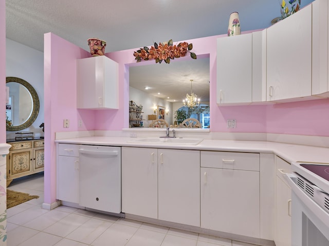 kitchen with white appliances, light countertops, a sink, and white cabinets