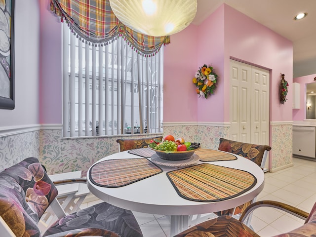 tiled dining area featuring a wainscoted wall, breakfast area, and recessed lighting