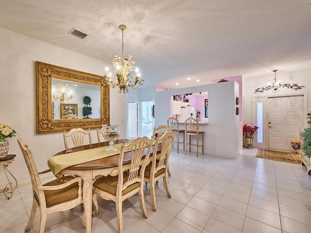 dining area with light tile patterned floors, visible vents, baseboards, and an inviting chandelier