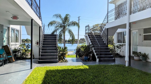 exterior space featuring stairway and a water view