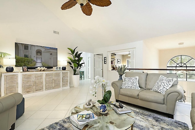 living room with a ceiling fan, visible vents, high vaulted ceiling, and light tile patterned floors