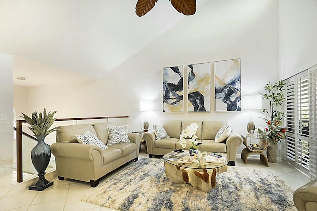 tiled living area with high vaulted ceiling and a ceiling fan