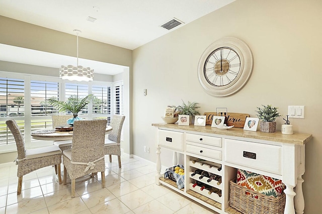 dining room with marble finish floor, visible vents, and baseboards