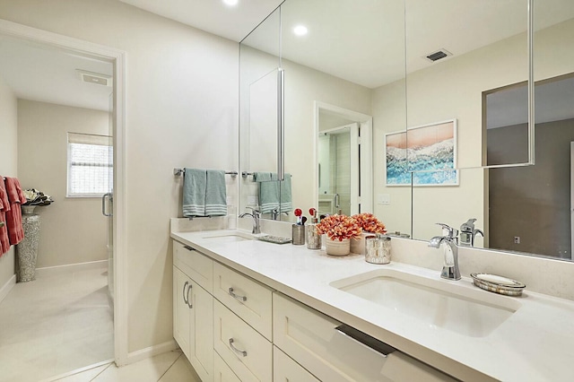 full bath with double vanity, a sink, visible vents, and tile patterned floors