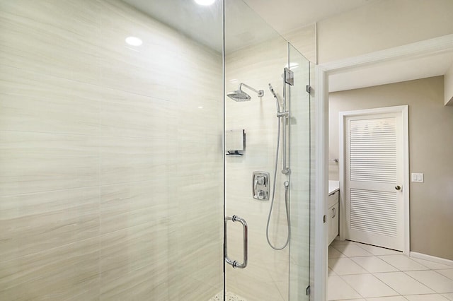 full bathroom with a shower stall, vanity, and tile patterned floors