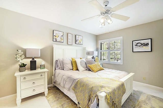 bedroom with light tile patterned flooring, ceiling fan, and baseboards