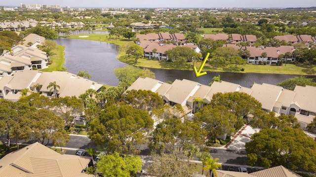 birds eye view of property with a water view and a residential view