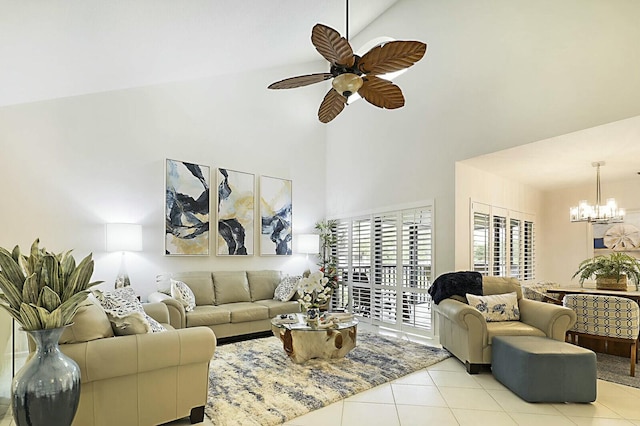 living room featuring light tile patterned floors, ceiling fan with notable chandelier, and a towering ceiling