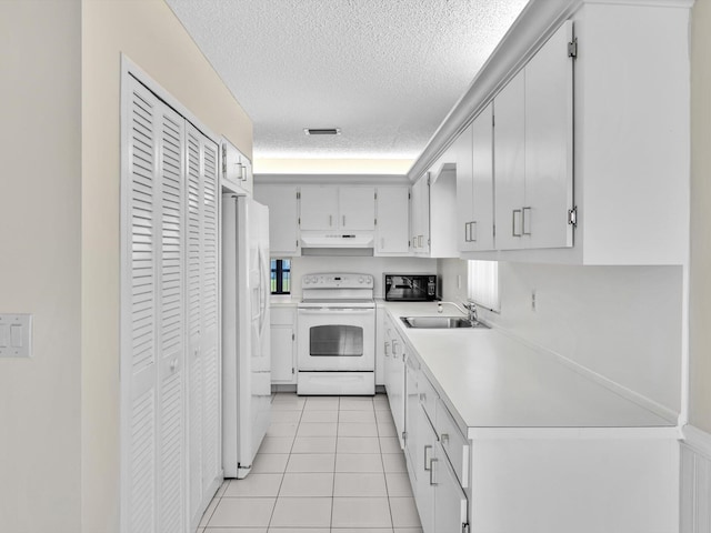 kitchen with white appliances, light tile patterned floors, a sink, light countertops, and under cabinet range hood