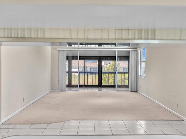 carpeted empty room with baseboards