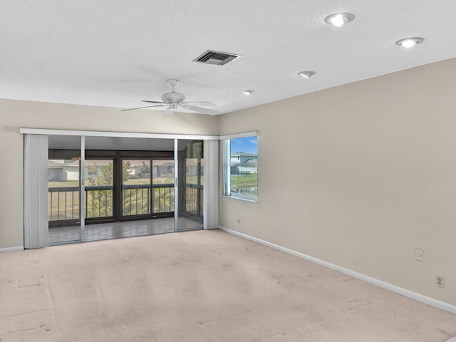 spare room featuring baseboards, visible vents, and carpet floors