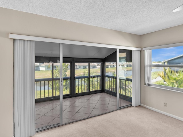 unfurnished sunroom with a water view