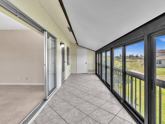 unfurnished sunroom with visible vents and vaulted ceiling