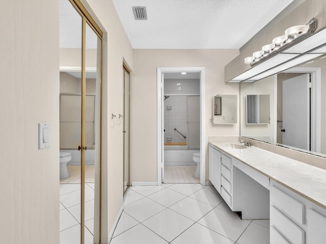 bathroom with tile patterned flooring, visible vents, toilet, and vanity