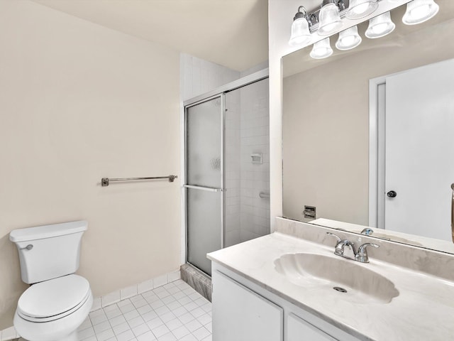 bathroom with vanity, baseboards, a stall shower, tile patterned flooring, and toilet