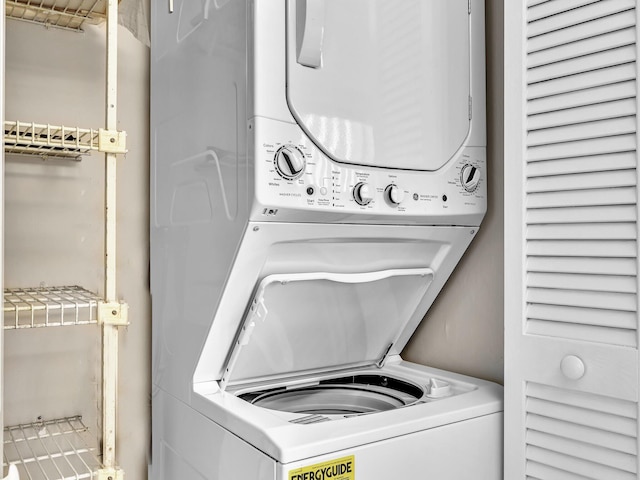 washroom featuring laundry area and stacked washing maching and dryer