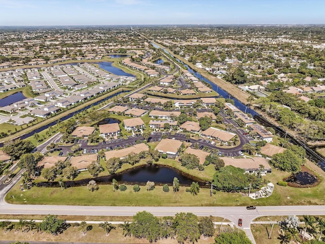 drone / aerial view with a residential view and a water view