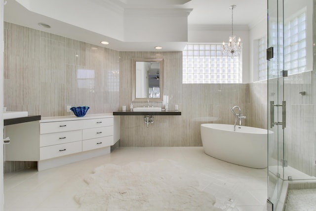 full bathroom featuring tile patterned flooring, tile walls, a freestanding bath, a stall shower, and crown molding