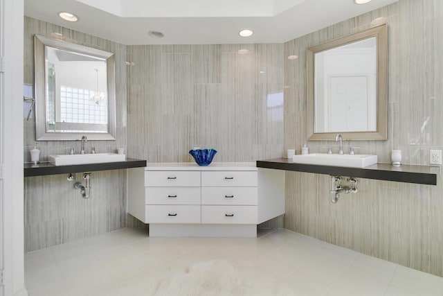 bathroom featuring a sink, tile walls, and tile patterned floors