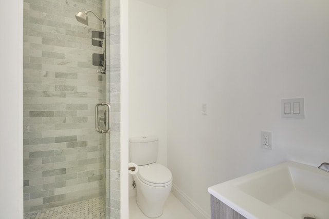 bathroom featuring a stall shower, a sink, and toilet