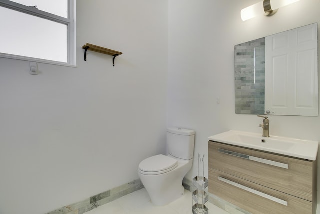 bathroom featuring tile patterned flooring, vanity, and toilet