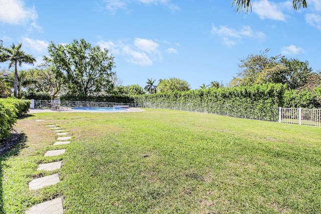 view of yard featuring fence and a fenced in pool