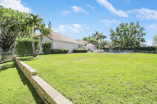 view of yard featuring fence and a fenced in pool